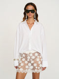 éliou Celia Mini Skirt in Gardenia — styled with oversized white button-down shirt and sunglasses